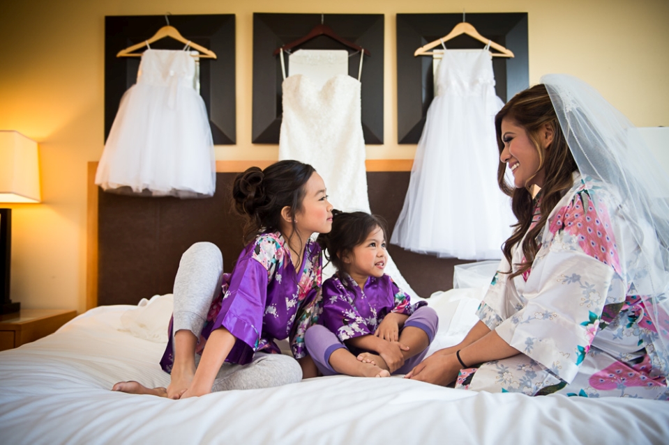 Bride and children on bed before the wedding.