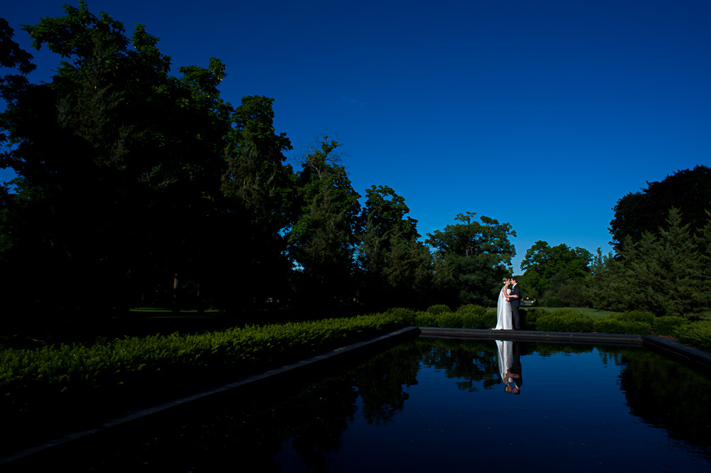 Wedding portrait in front of a reflective pool.
